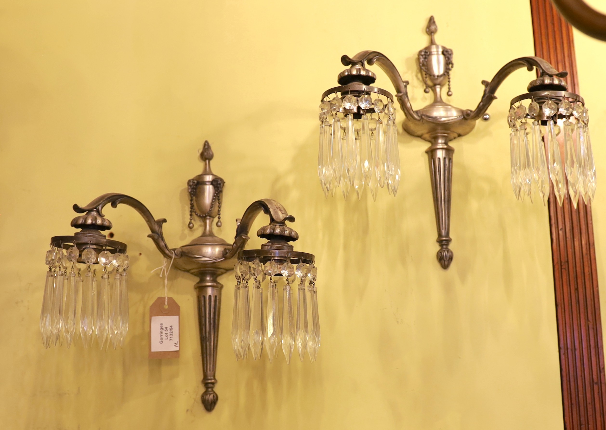 A pair of early 20th century English silver brass wall lights with cut glass drops, height 35cm